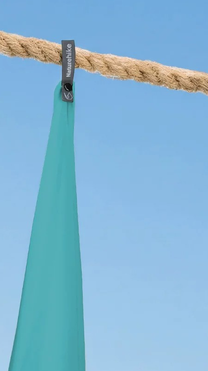 Original supplier close-up of lake-green Naturehike towel fabric and its branded hanging tab.
