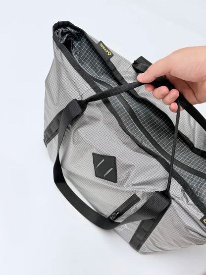 ETROL outdoor tote bag handle zipper and grid fabric detail